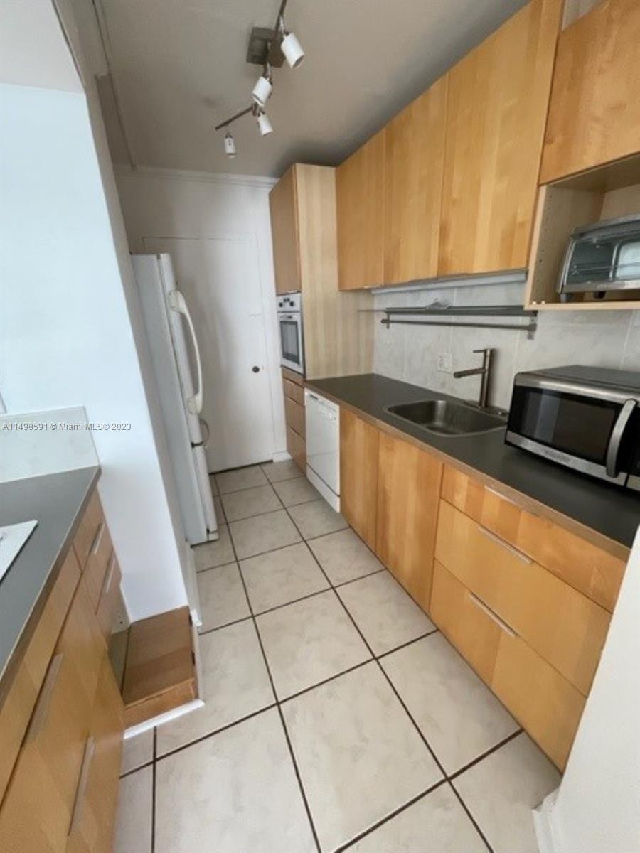 Millionaire's Row Miami Beach, FL 33140 - Photo 16 of 16 a kitchen with stainless steel appliances a refrigerator sink and microwave