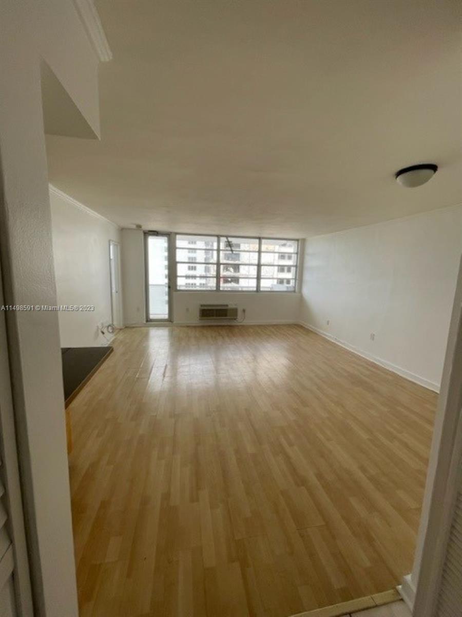 Millionaire's Row Miami Beach, FL 33140 - Photo 3 of 16 an empty room with wooden floor and windows