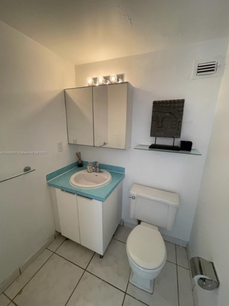 Millionaire's Row Miami Beach, FL 33140 - Photo 7 of 16 a bathroom with a toilet a sink and mirror