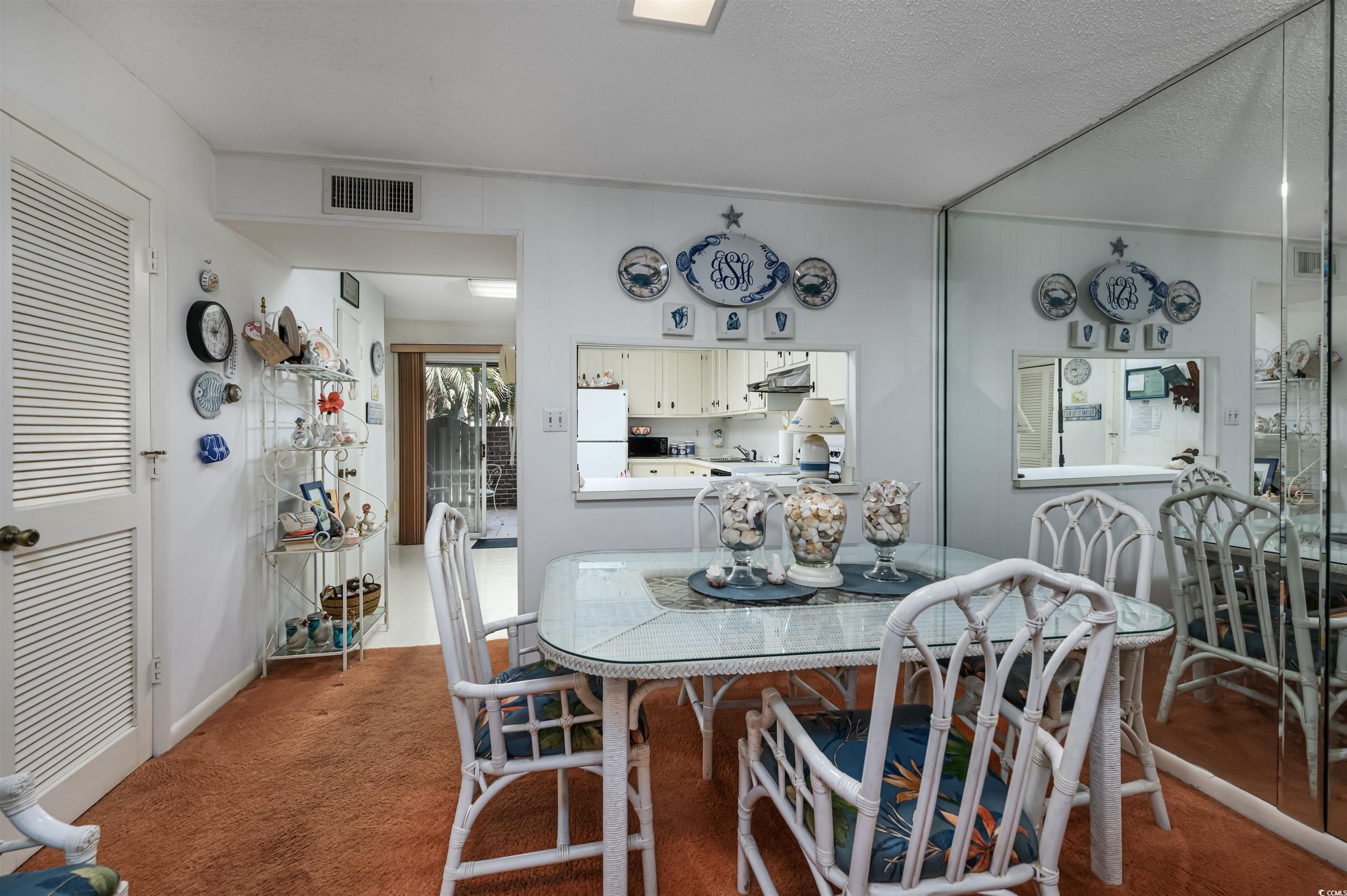 10200 Lakeshore Drive, Unit 16 Myrtle Beach, SC 29572 - Photo 23 of 36 Dining room featuring carpet, visible vents, and a textured ceiling