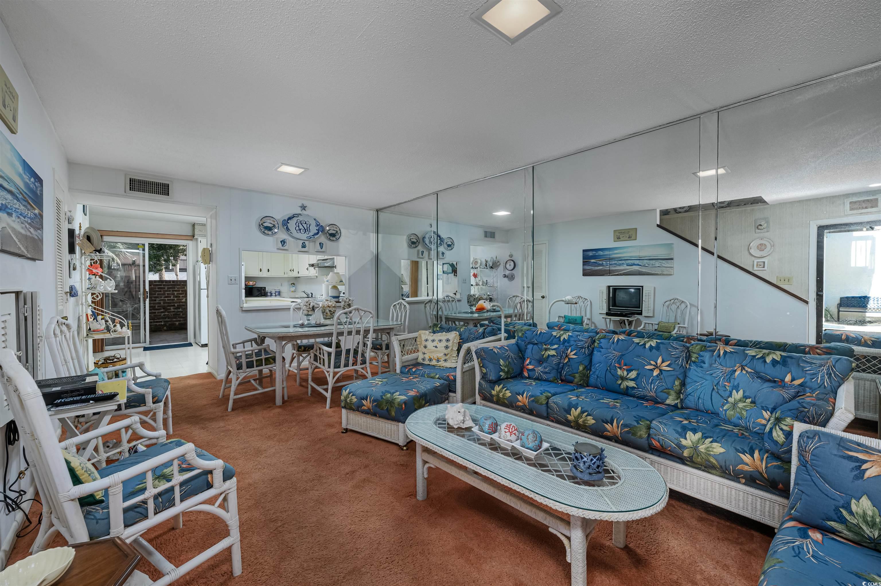 10200 Lakeshore Drive, Unit 16 Myrtle Beach, SC 29572 - Photo 24 of 36 Living room with carpet floors, visible vents, and a textured ceiling