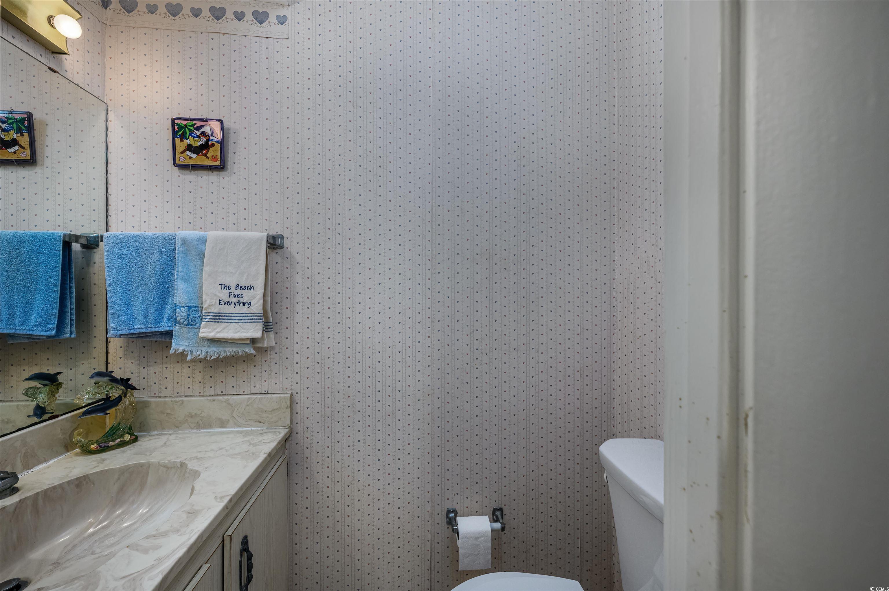 10200 Lakeshore Drive, Unit 16 Myrtle Beach, SC 29572 - Photo 26 of 36 Half bathroom featuring toilet and vanity