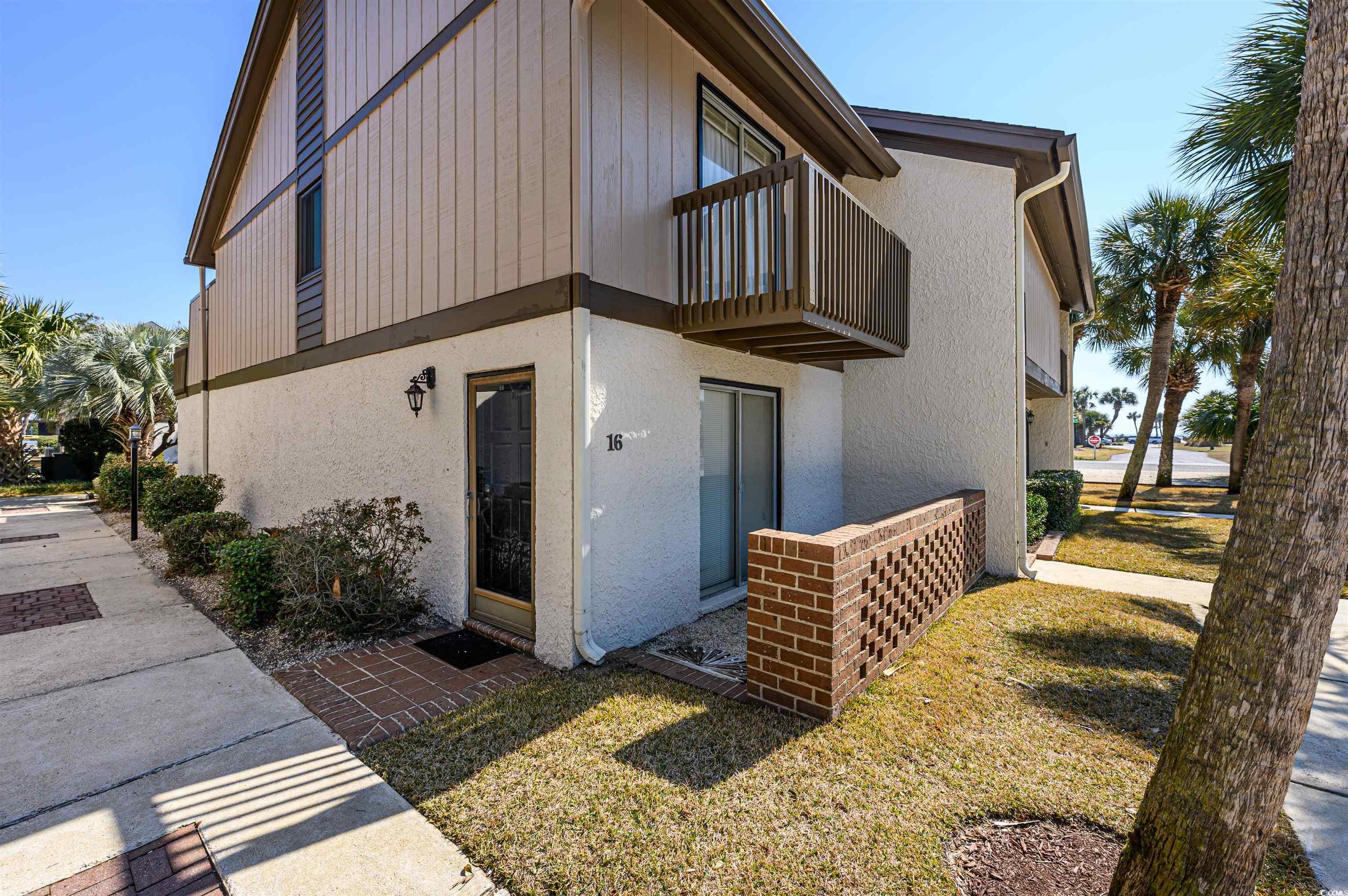 10200 Lakeshore Drive, Unit 16 Myrtle Beach, SC 29572 - Photo 4 of 36 View of property exterior featuring a balcony and stucco siding