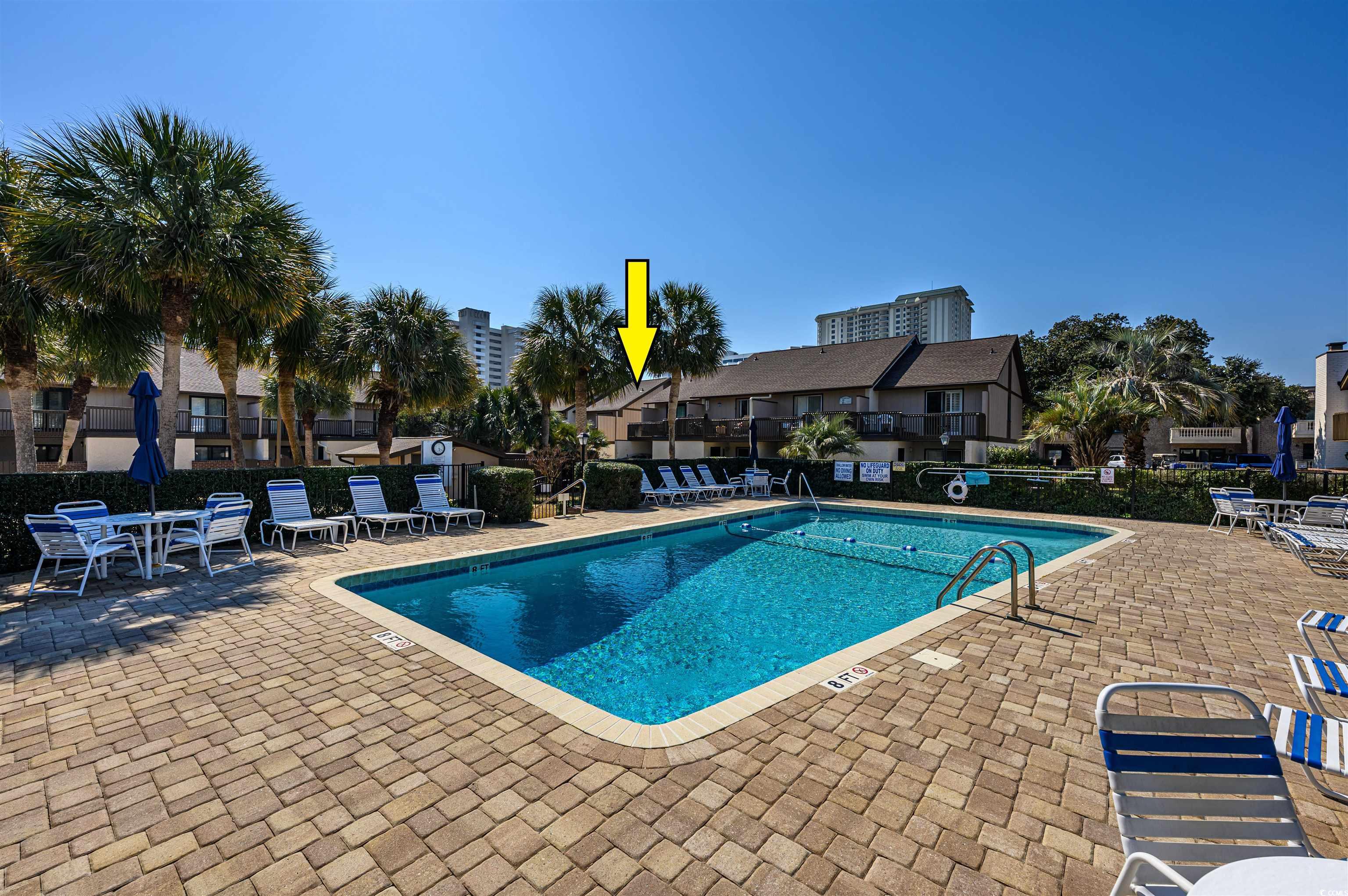 10200 Lakeshore Drive, Unit 16 Myrtle Beach, SC 29572 - Photo 7 of 36 Community pool featuring a patio area and fence