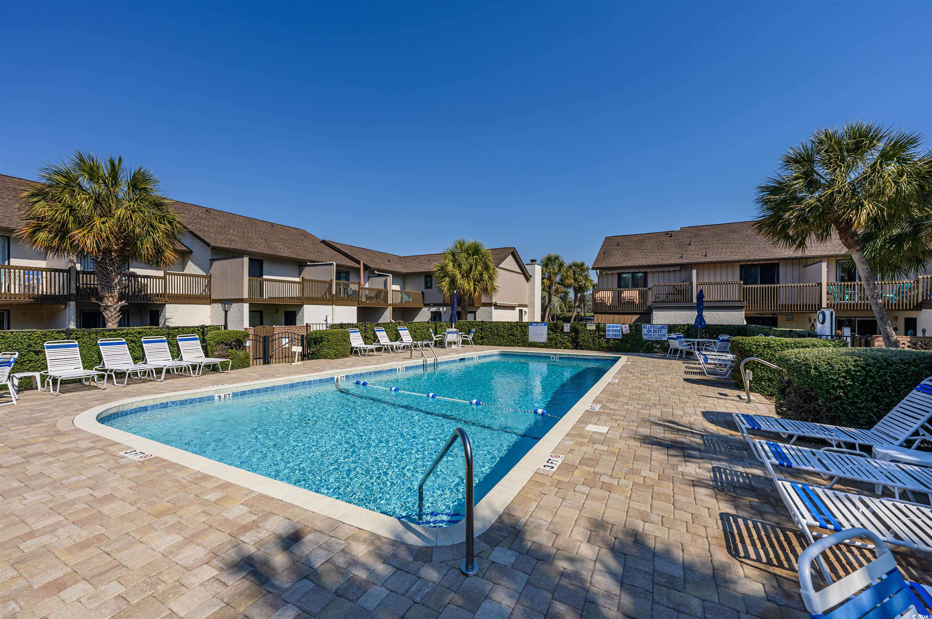 10200 Lakeshore Drive, Unit 16 Myrtle Beach, SC 29572 - Photo 8 of 36 Pool featuring a patio area, a residential view, and fence