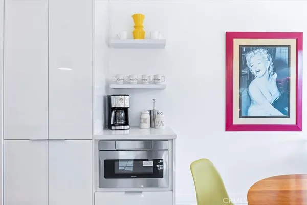 a kitchen with stainless steel appliances granite countertop a sink and a refrigerator