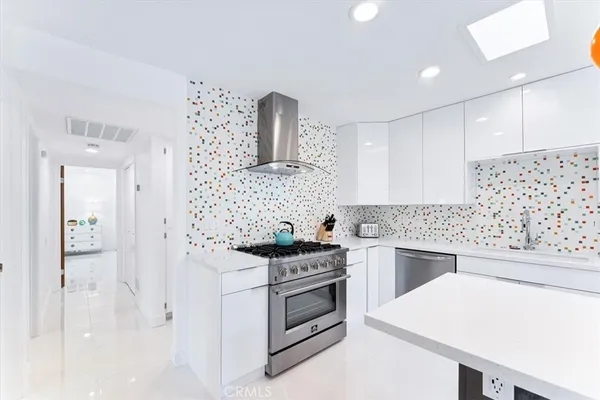 a kitchen with granite countertop a stove and a refrigerator