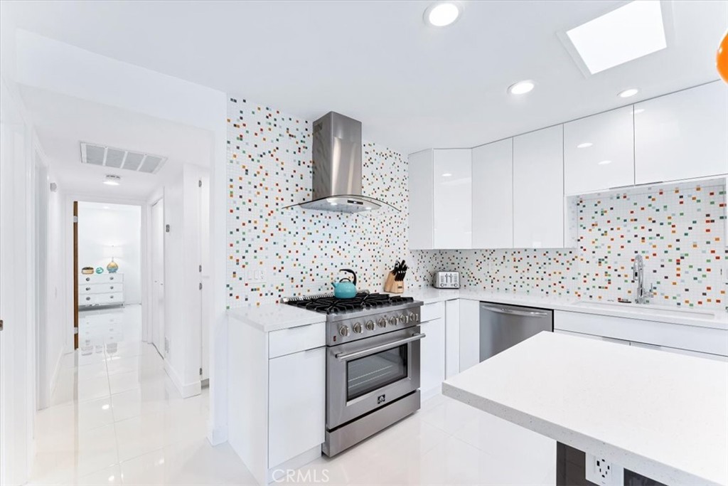 1111 Ramon Road, Unit 87 Palm Springs, CA 92264 - Photo 15 of 54 a kitchen with white cabinets and appliances
