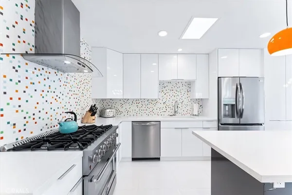 a kitchen with a sink a stove and chairs