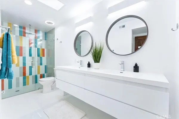 a bathroom with a tub sink and mirror