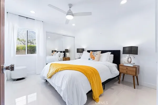 a bed room with a bed and a chair