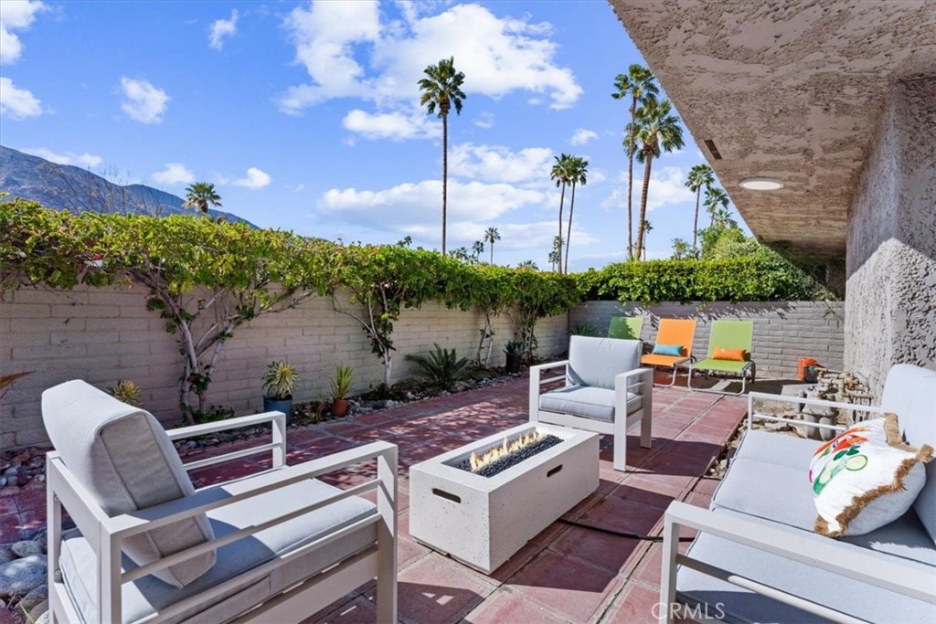 1111 Ramon Road, Unit 87 Palm Springs, CA 92264 - Photo 40 of 54 a view of a patio with couches chairs and a potted plant