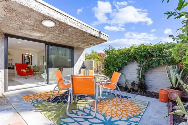 a view of a swimming pool with a patio and plants