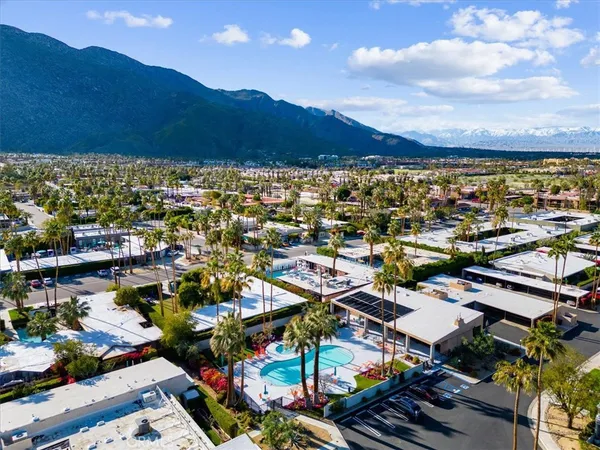 a reading room with furniture book shelf and a large window