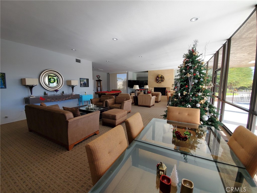 1111 Ramon Road, Unit 87 Palm Springs, CA 92264 - Photo 52 of 54 a living room with furniture a window and a clock