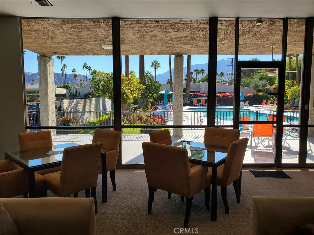 1111 Ramon Road, Unit 87 Palm Springs, CA 92264 - Photo 54 of 54 a dining room with furniture and a floor to ceiling window