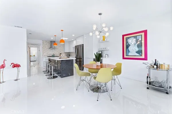 a dining room with furniture and chandelier
