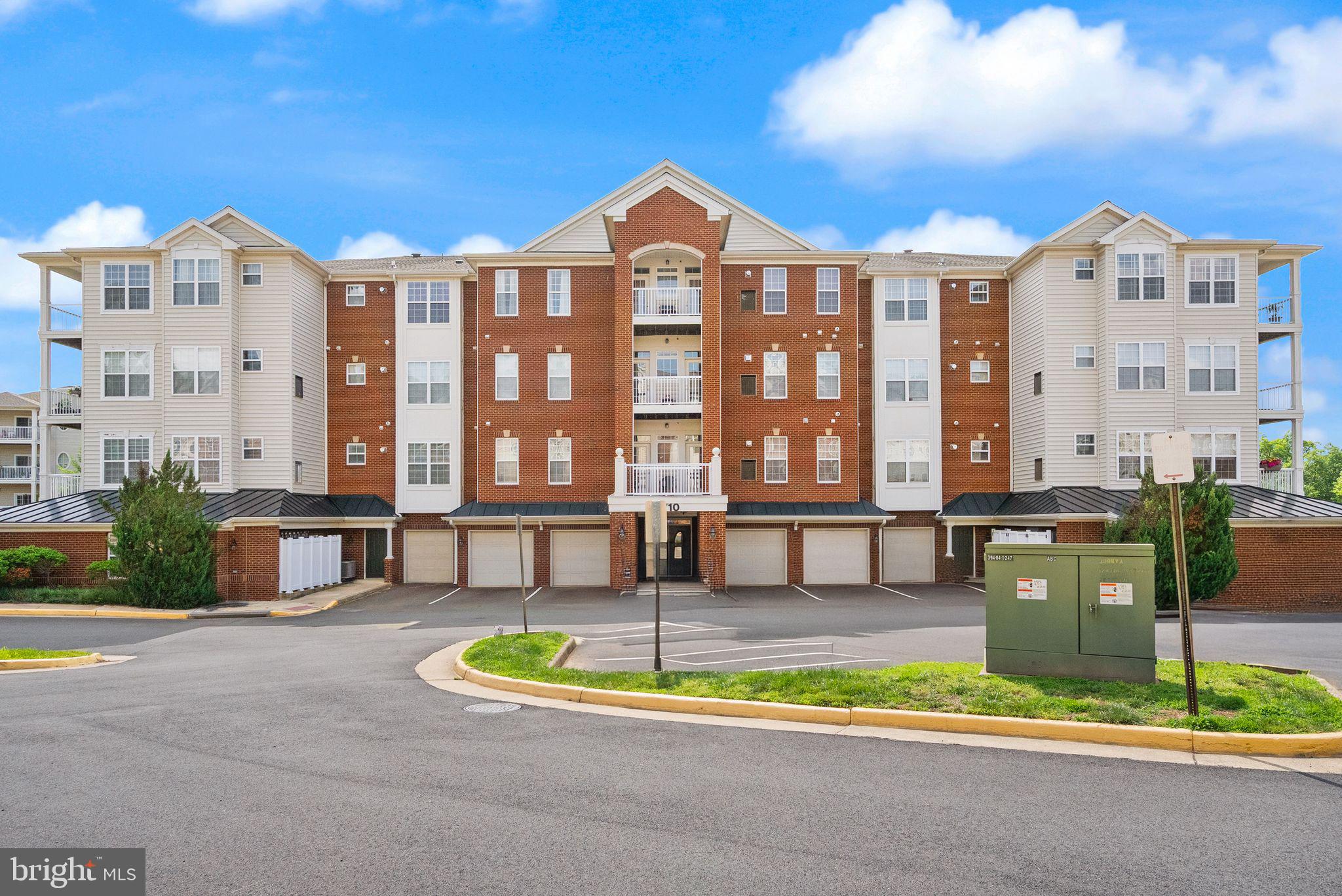 9710 Handerson Place, Unit 1 Manassas Park, VA 20111 - Photo 1 of 41 a front view of a building with a garden and plants