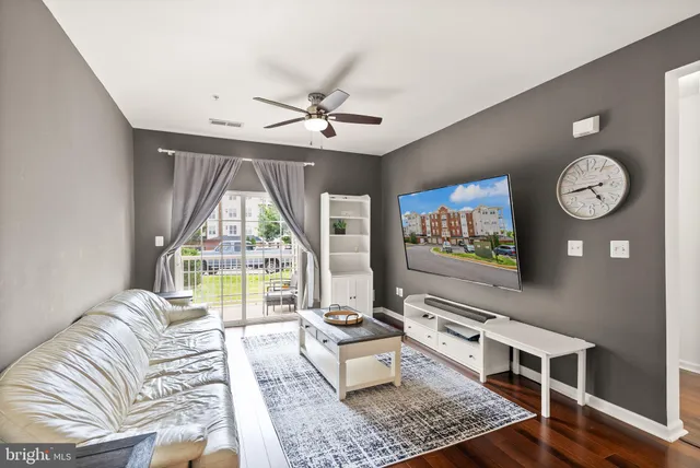 a living room with couch and a large window