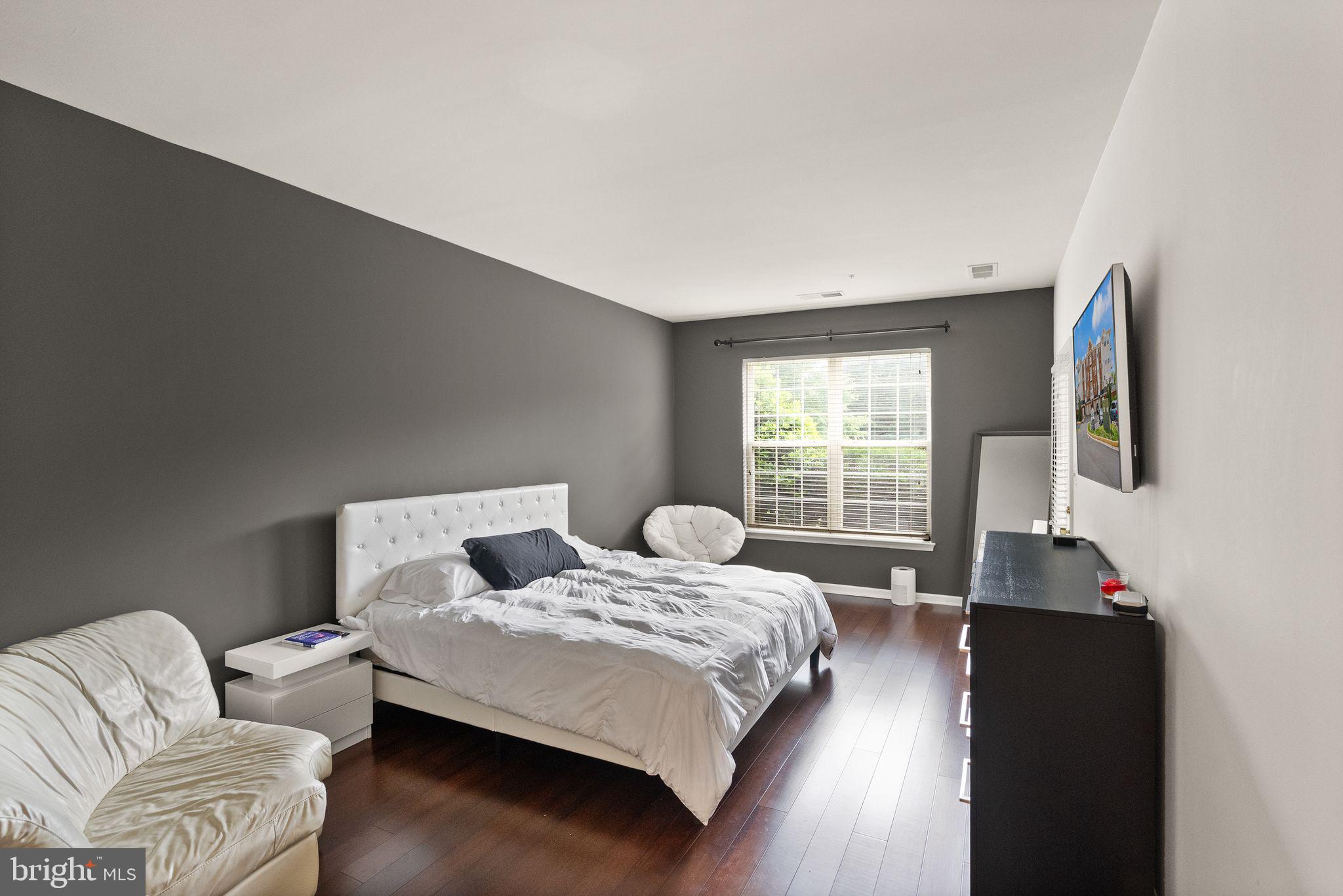 9710 Handerson Place, Unit 1 Manassas Park, VA 20111 - Photo 17 of 41 a bedroom with a bed and wooden floor