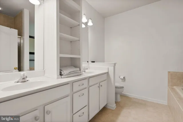 a bathroom with a sink double vanity granite and a mirror