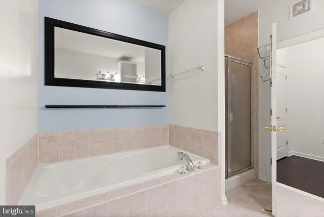 a bathroom with a glass shower door