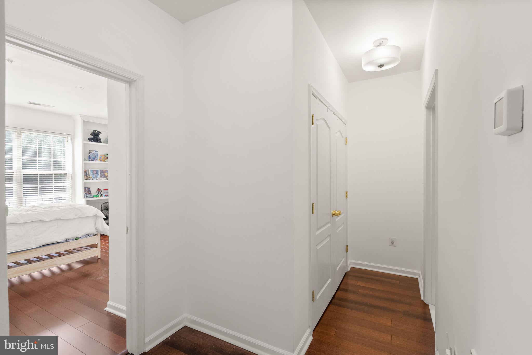 9710 Handerson Place, Unit 1 Manassas Park, VA 20111 - Photo 27 of 41 a view of a hallway with wooden floor and a living room