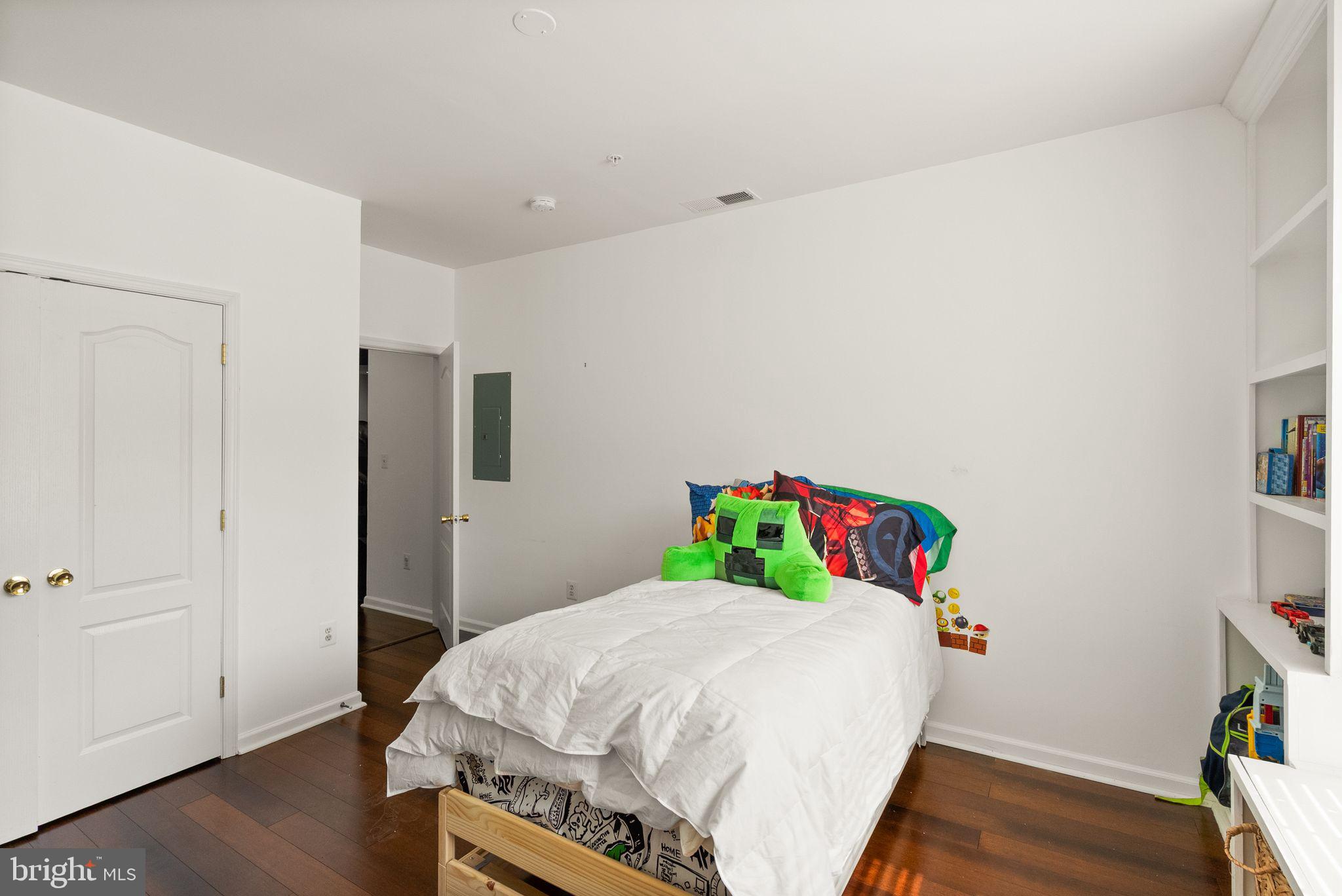 9710 Handerson Place, Unit 1 Manassas Park, VA 20111 - Photo 29 of 41 a bedroom with a bed and wooden floor