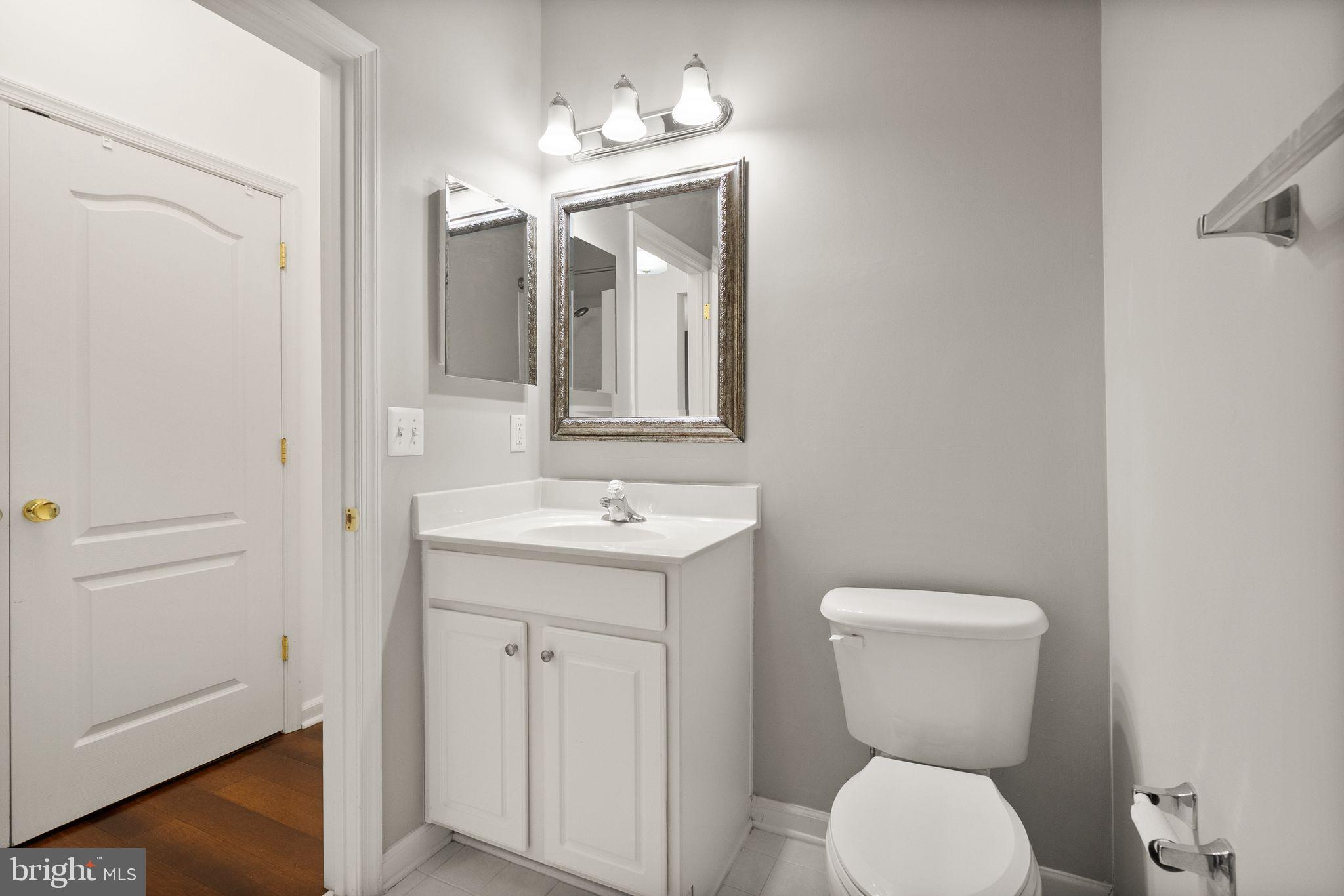 9710 Handerson Place, Unit 1 Manassas Park, VA 20111 - Photo 31 of 41 a bathroom with a toilet sink and mirror