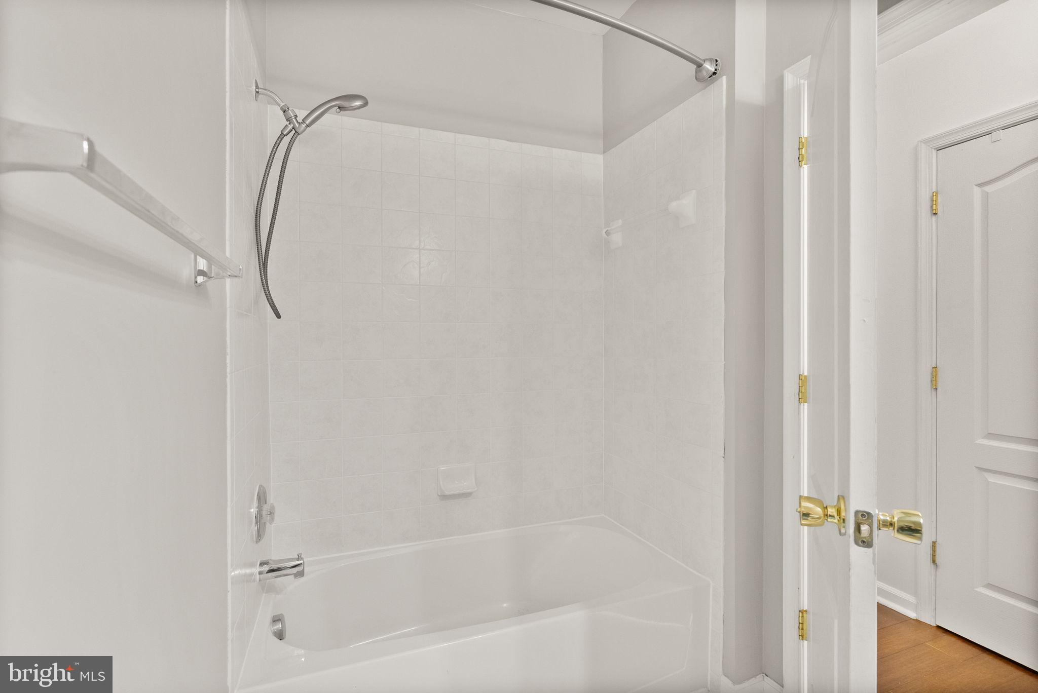 9710 Handerson Place, Unit 1 Manassas Park, VA 20111 - Photo 32 of 41 a bathroom with a bathtub and a shower