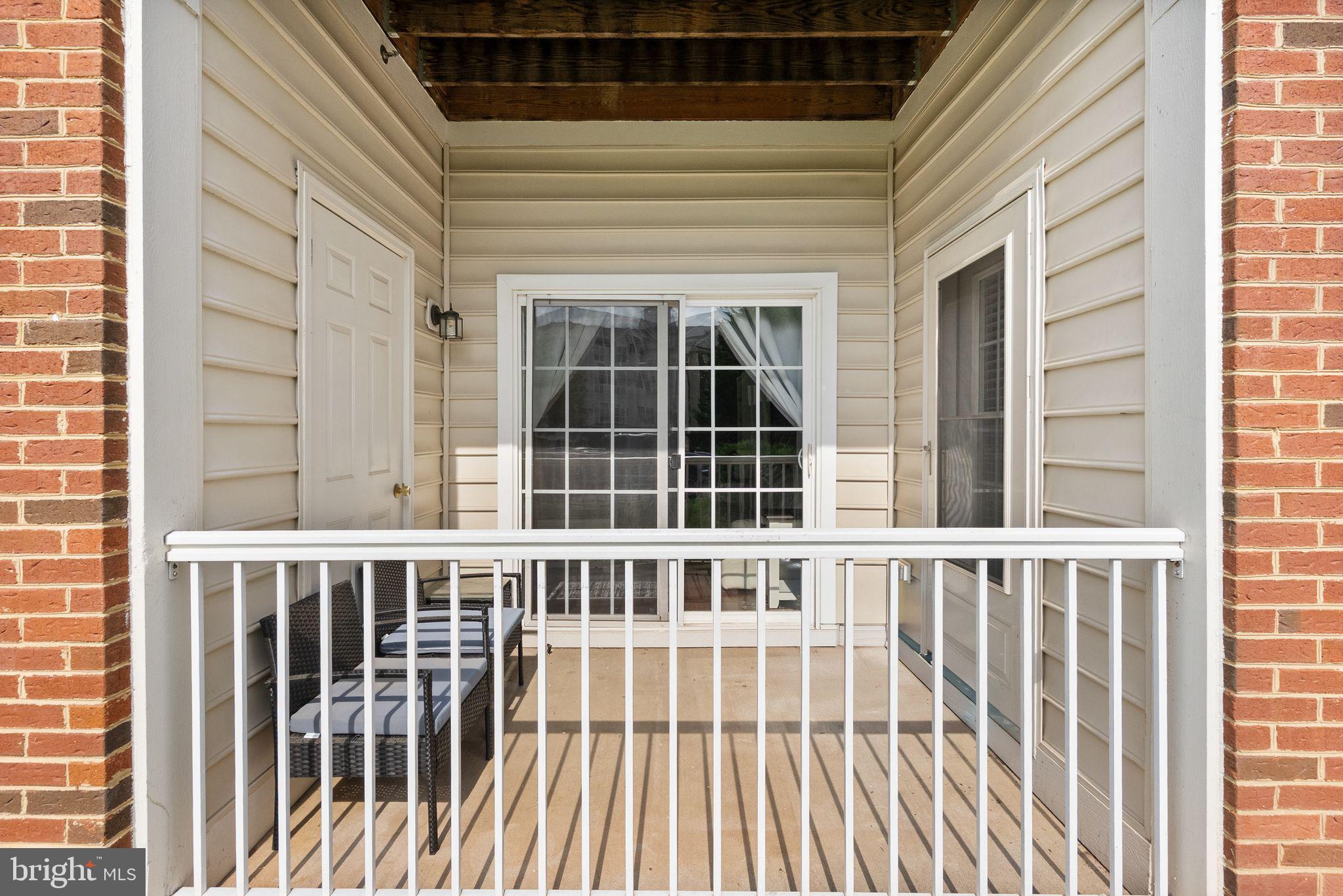9710 Handerson Place, Unit 1 Manassas Park, VA 20111 - Photo 36 of 41 a view of a brick house with large windows