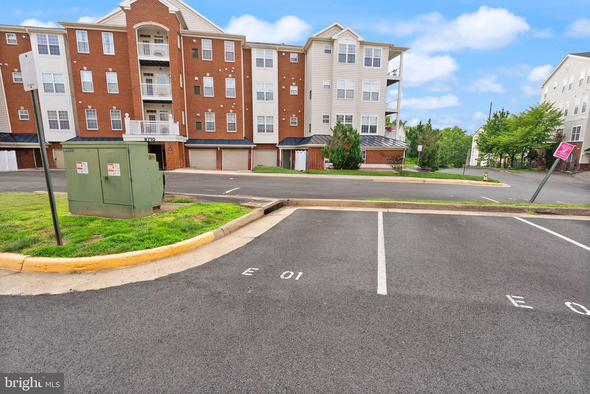 9710 Handerson Place, Unit 1 Manassas Park, VA 20111 - Photo 39 of 41 a front view of a multi story residential apartment building with a yard