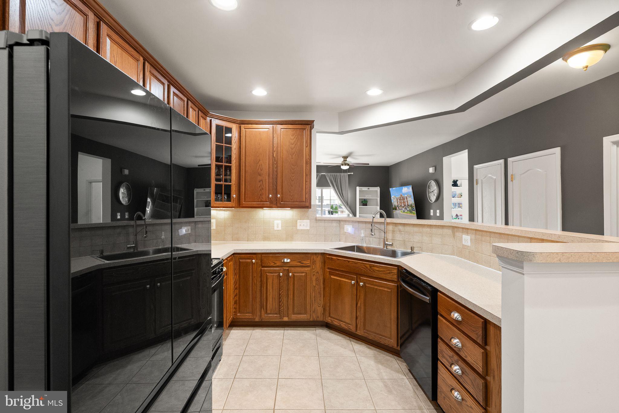 9710 Handerson Place, Unit 1 Manassas Park, VA 20111 - Photo 8 of 41 a large kitchen with a sink and cabinets