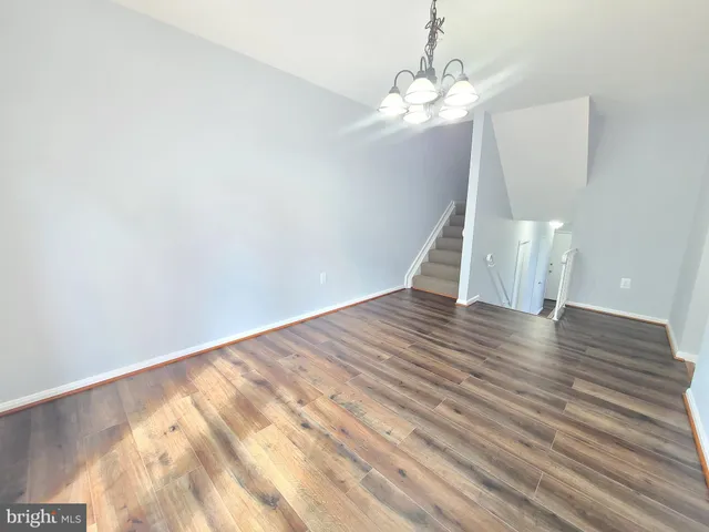 a view of a room with wooden floor and staircase