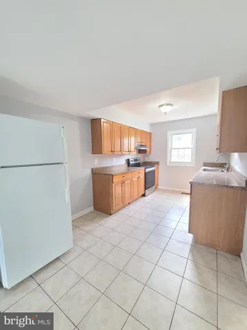 a kitchen with stainless steel appliances granite countertop a refrigerator sink and cabinets