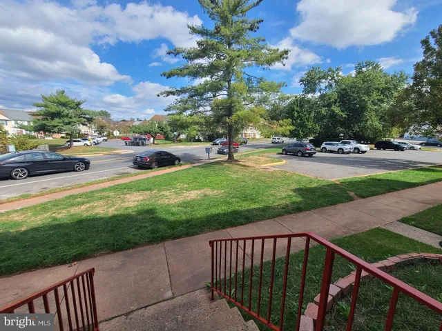 a view of a backyard with wooden fence