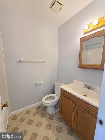 a bathroom with a sink a toilet and a mirror