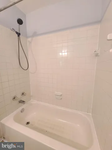 a bathroom with a bath tub with a shower