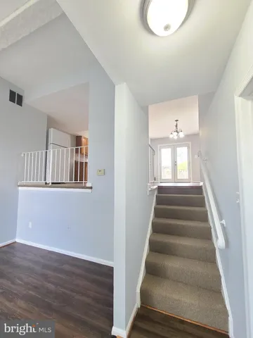 a view of an entryway with wooden floor