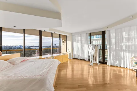 a large white kitchen with a large window