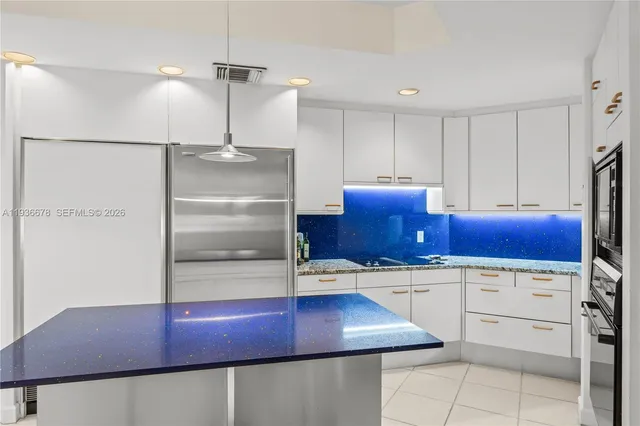 a bedroom with a large bed and a flat tv screen on the dresser