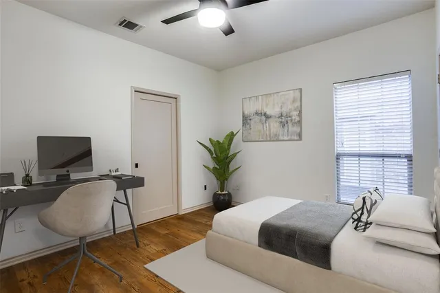 a bedroom with a bed and a chair