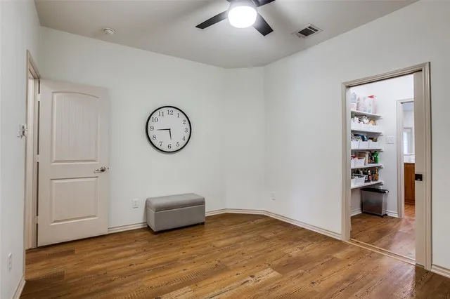 a view of a room with wooden floor and white walls