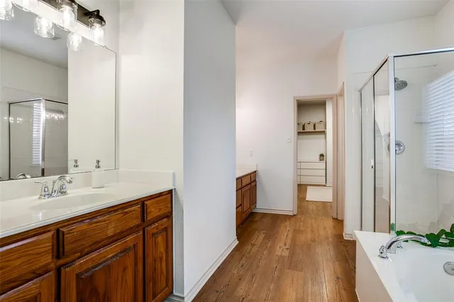 a spacious bathroom with a sink and a mirror