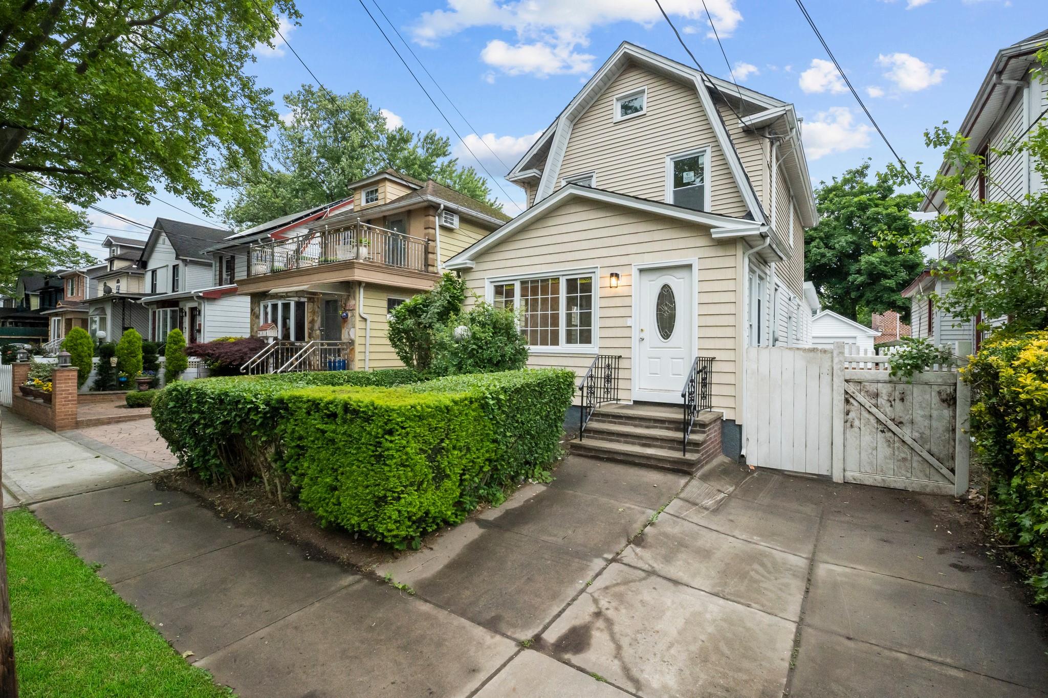 110-28 213th Street Queens, NY 11429 - Photo 19 of 22 View of front of house with a gate, a gambrel roof, and entry steps
