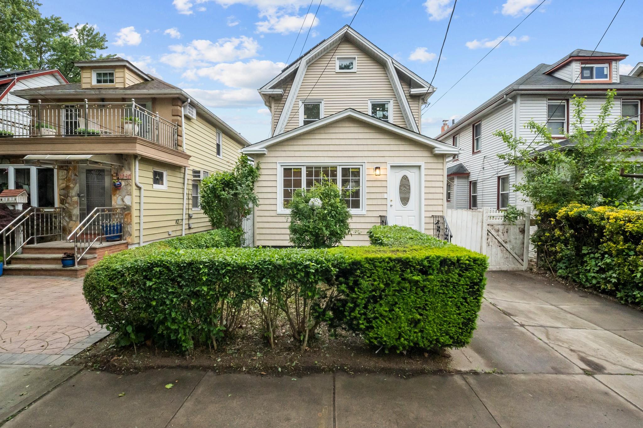 110-28 213th Street Queens, NY 11429 - Photo 20 of 22 View of front facade featuring a balcony and a gate