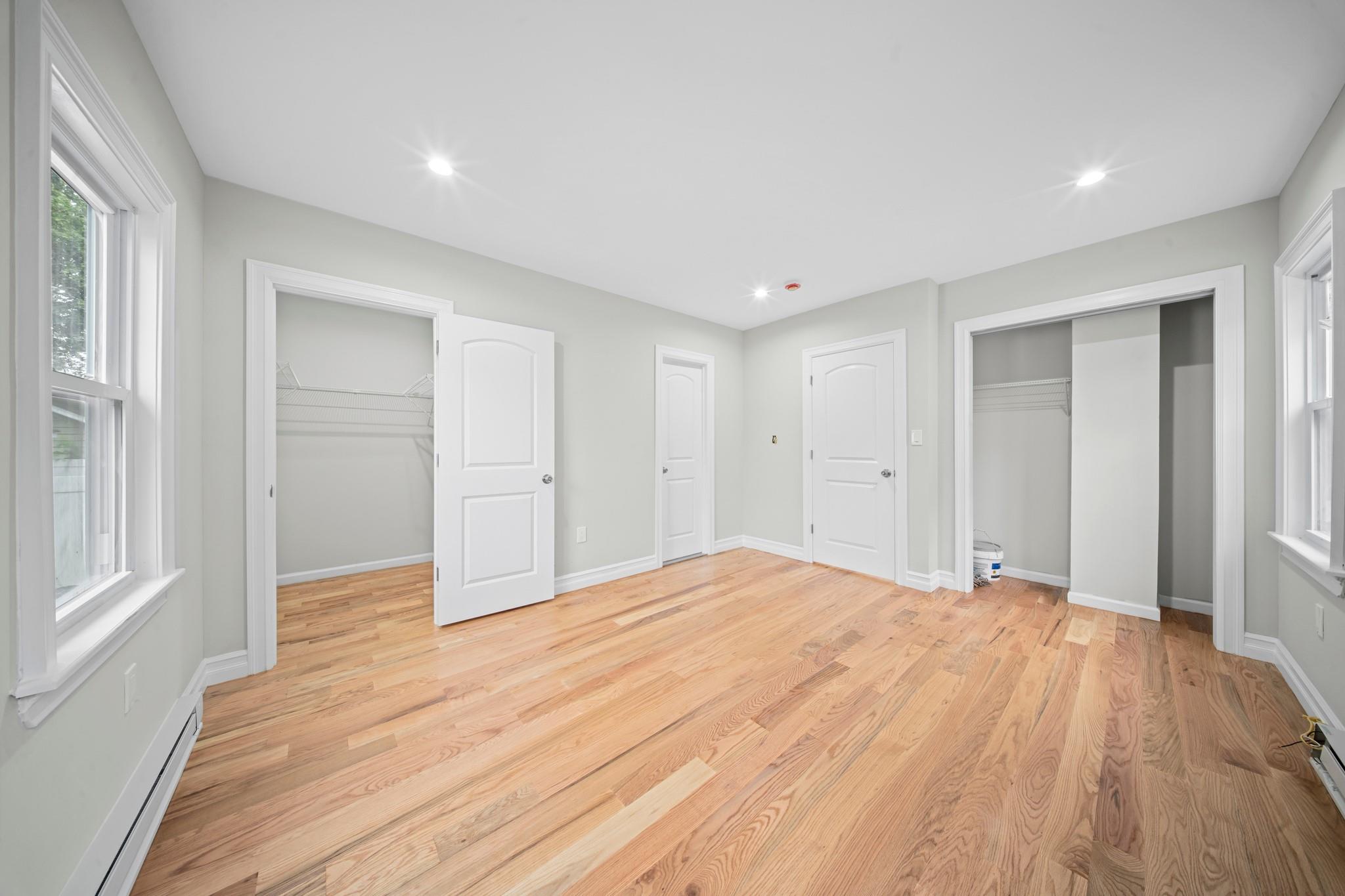 110-28 213th Street Queens, NY 11429 - Photo 8 of 22 Unfurnished bedroom featuring baseboard heating, light wood-style flooring, baseboards, and recessed lighting