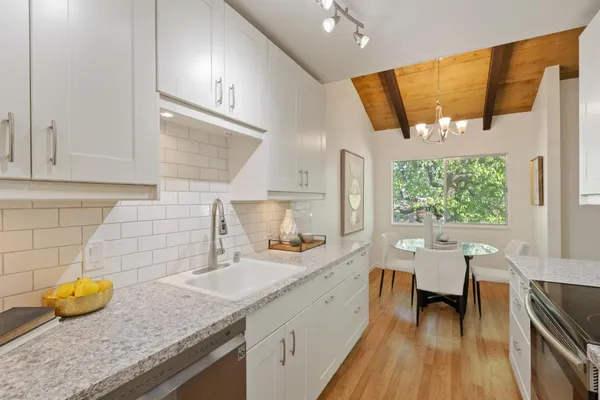 a bathroom with a granite countertop sink mirror and view