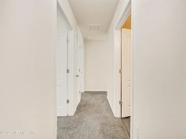 a view of a hallway with white walls