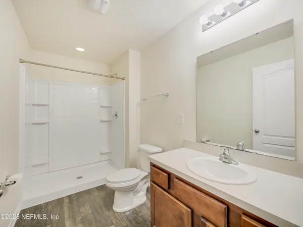 a bathroom with a sink toilet and shower